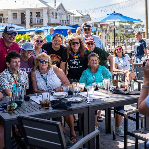 group of people posing for a photo at Zeke's waterfront restaurant in Orange Beach